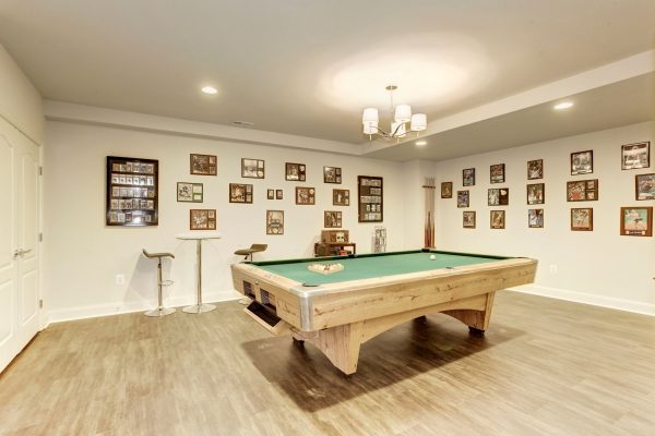 Billiards room with images of movies on the walls.