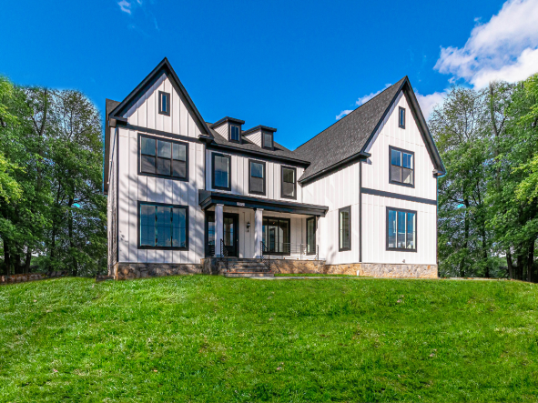 Exterior of the Hampton II. White vertical siding with a brown rood. 