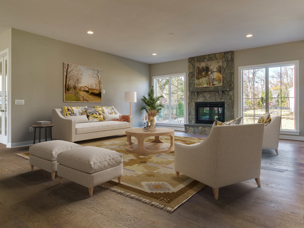 Living room. Fireplace in center of the room with artwork on the walls. 